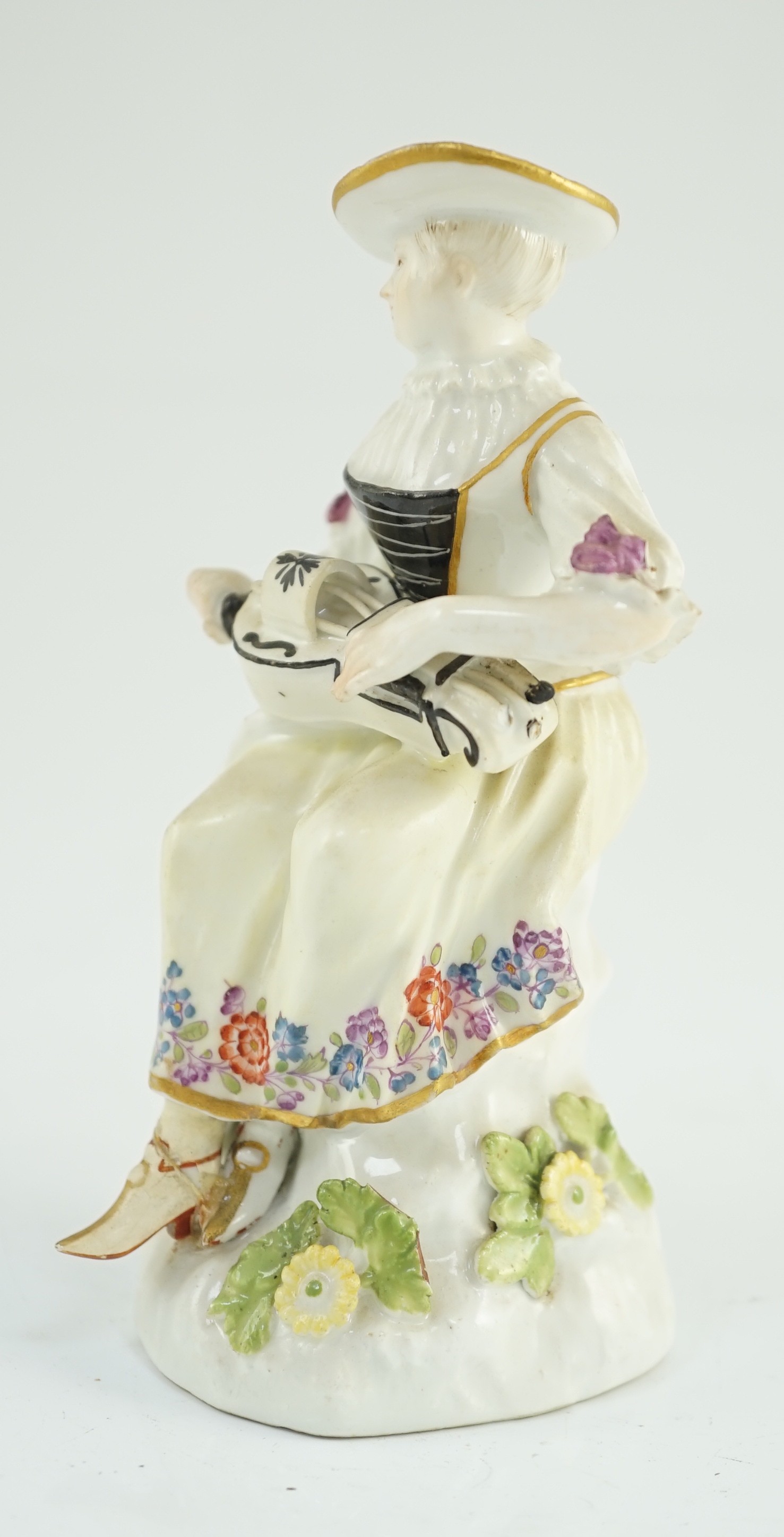 A Meissen porcelain figure of a woman playing the hurdy gurdy, mid 18th century, possibly modelled by J. J. Kandler, 13cm high, restored right foot, Provenance - purchased from Winifred Williams, Eastbourne/London before